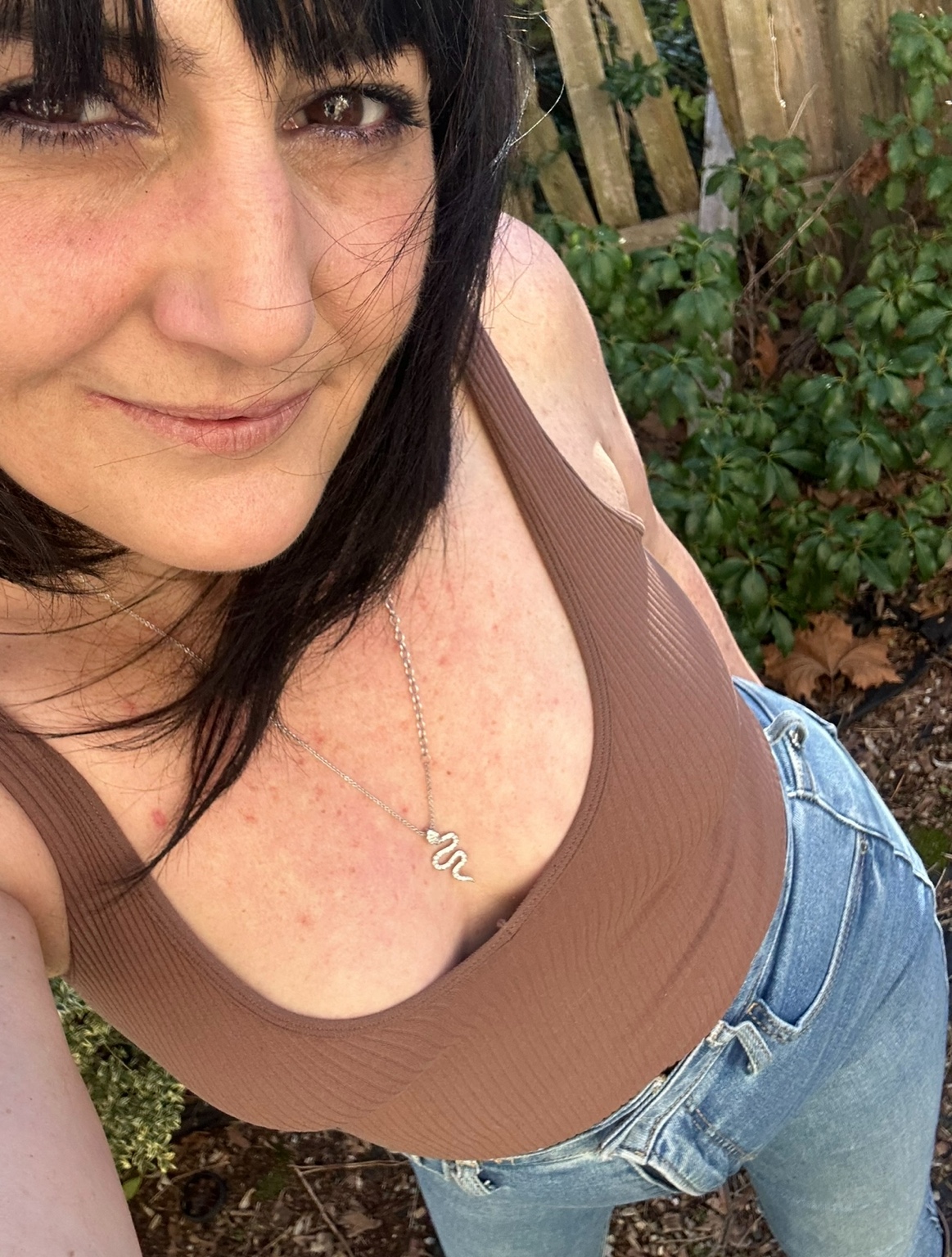 Kim Arciuolo outdoors, wearing her serpent necklace